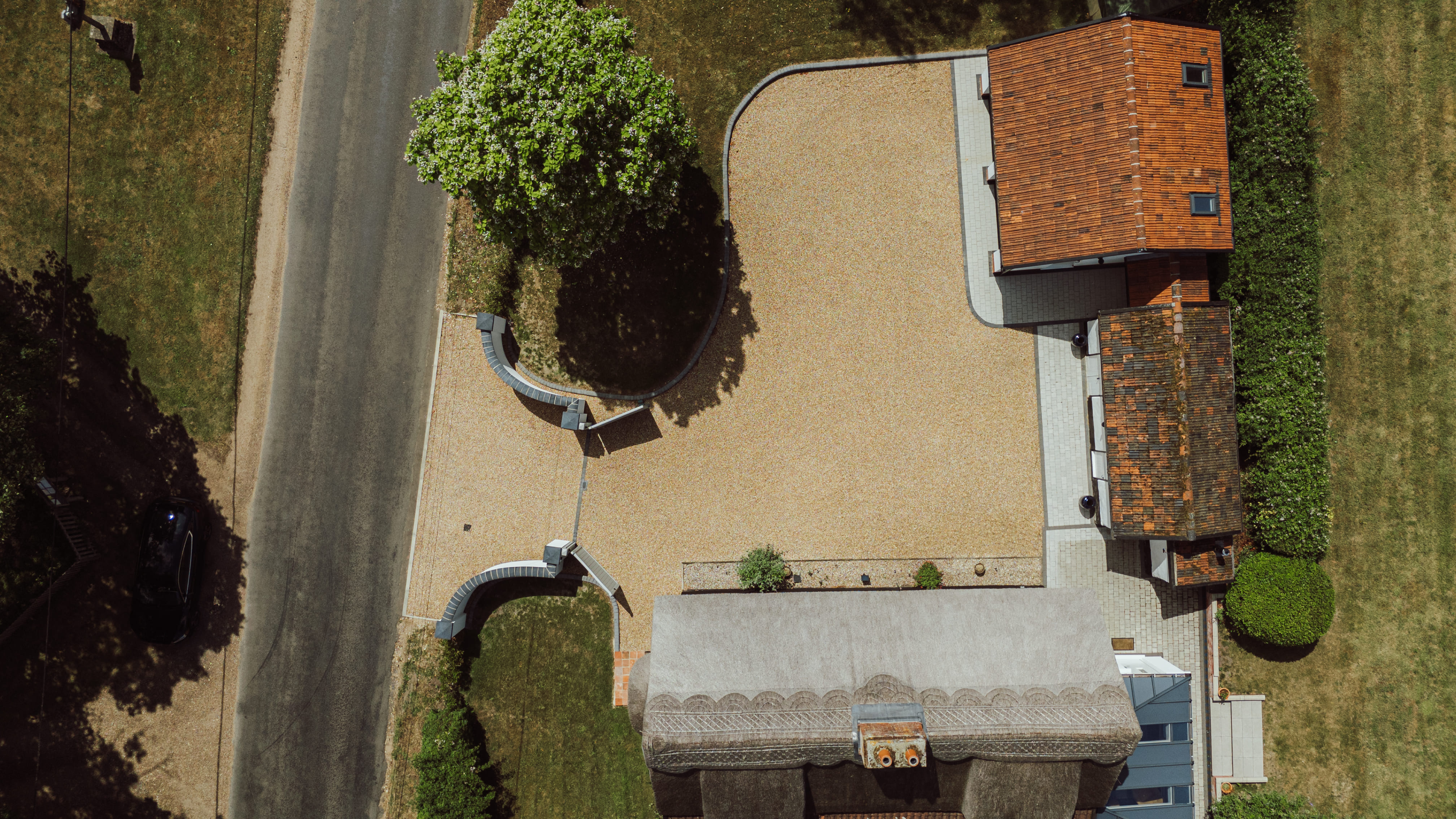 Top down view of Church Cottage and its gravel driveway. 