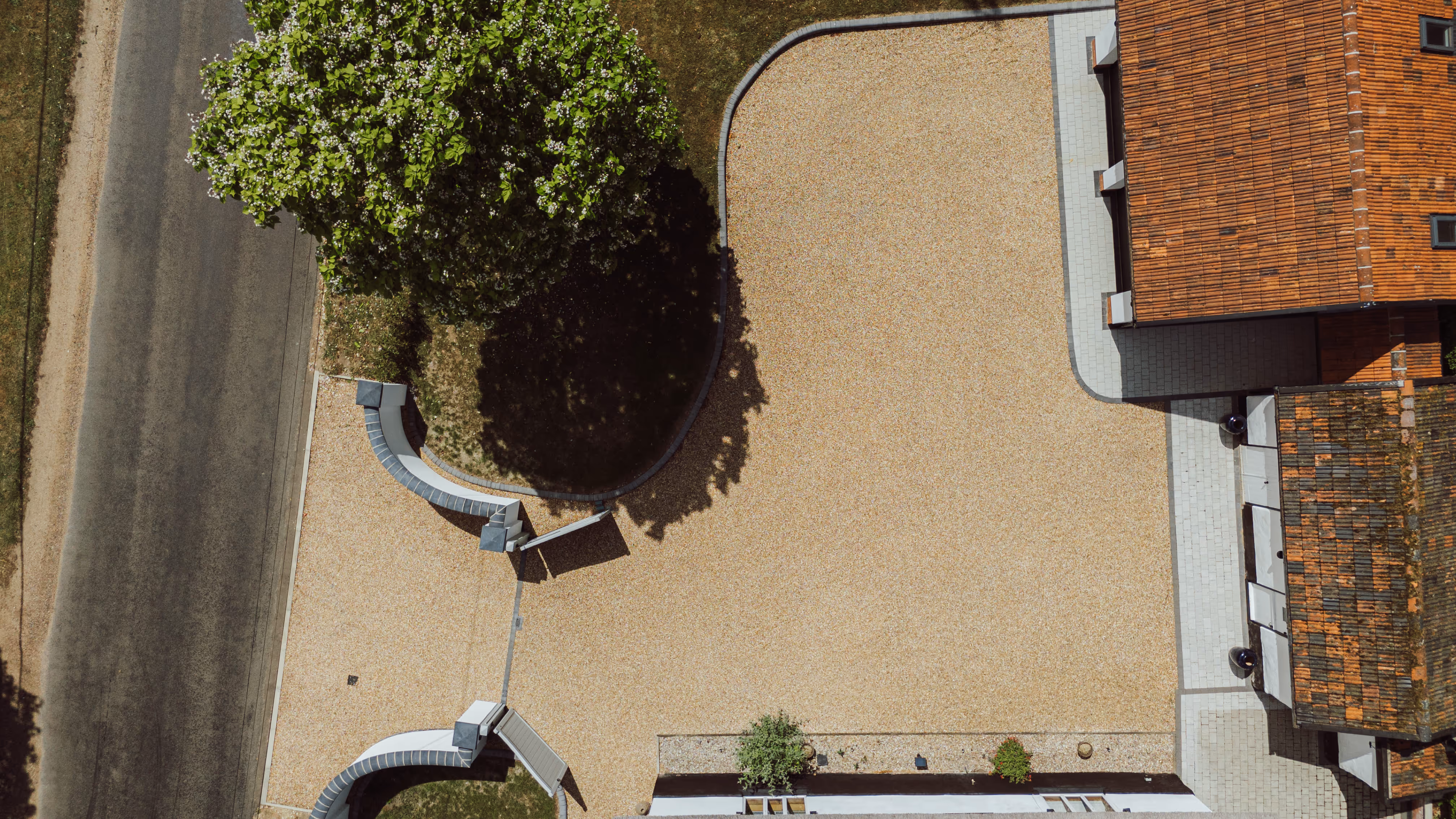 Top Down Ariel view of Church Cottage, visible in the shot is the gravel driveway, curved features and rendered walls.