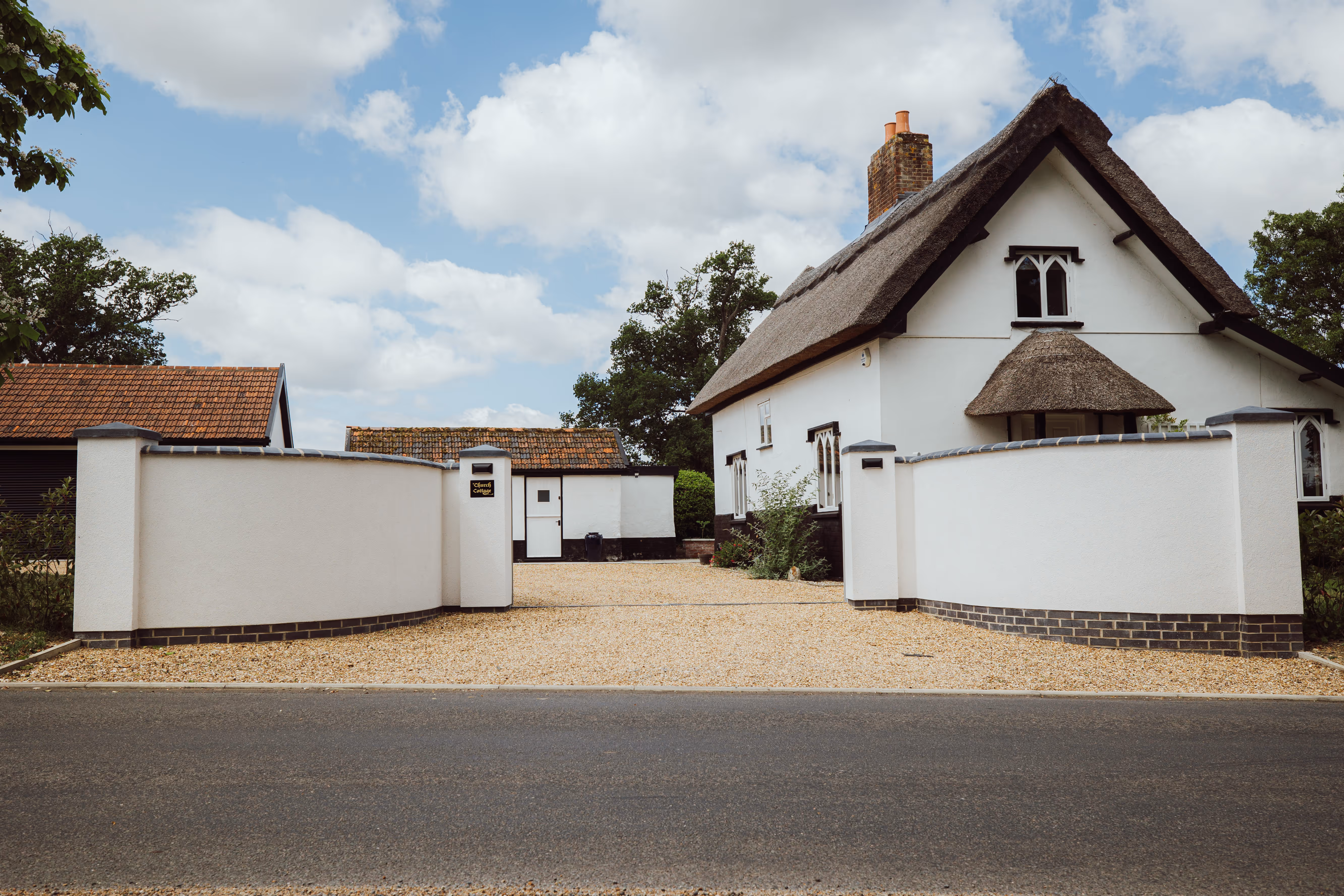 Street View of Church Cottage, you can see white rendered walls and a newly fitted gravel driveway. 