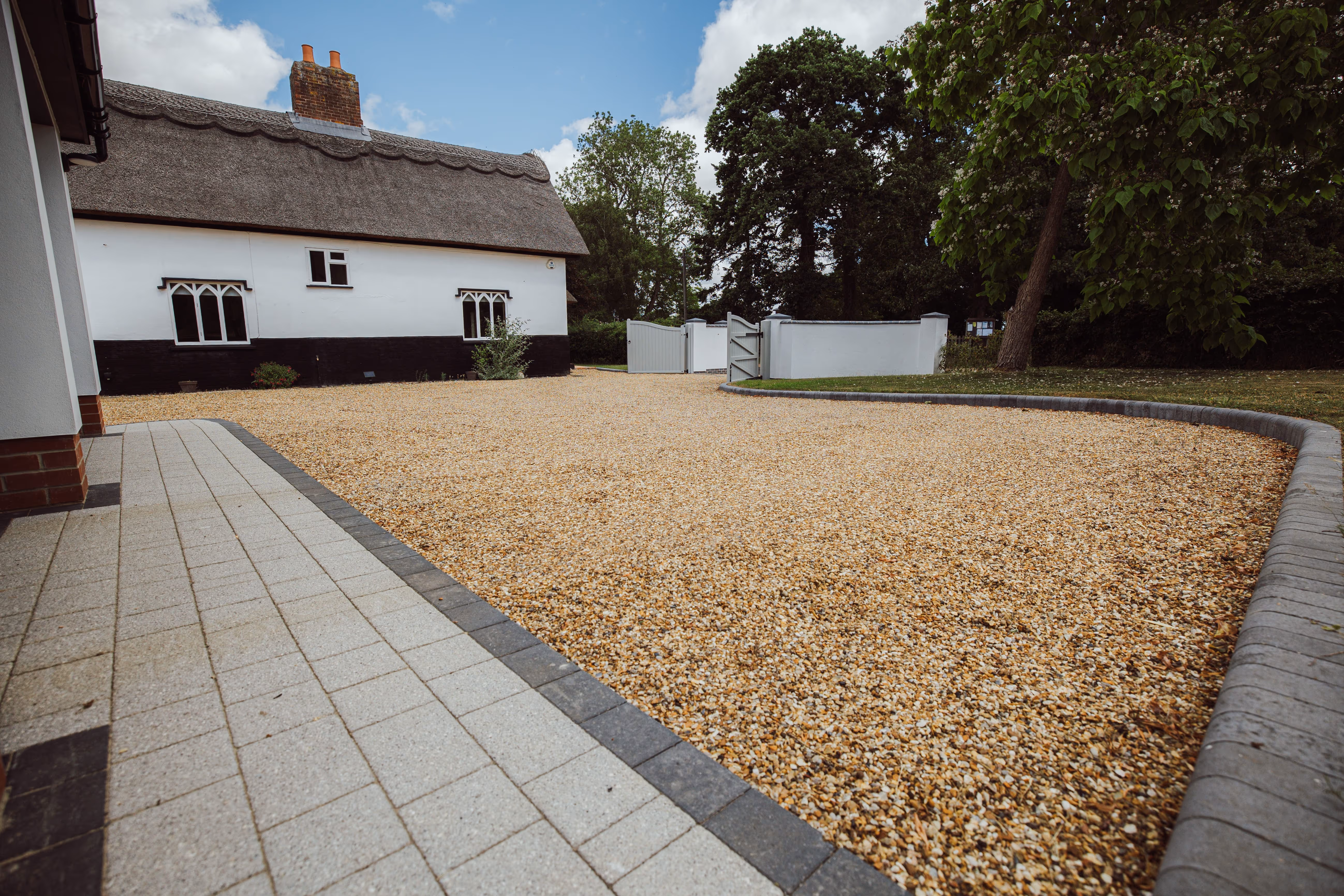 Gravel Driveway, Granite and Sandstone paving with curved features at Church Cottage. 