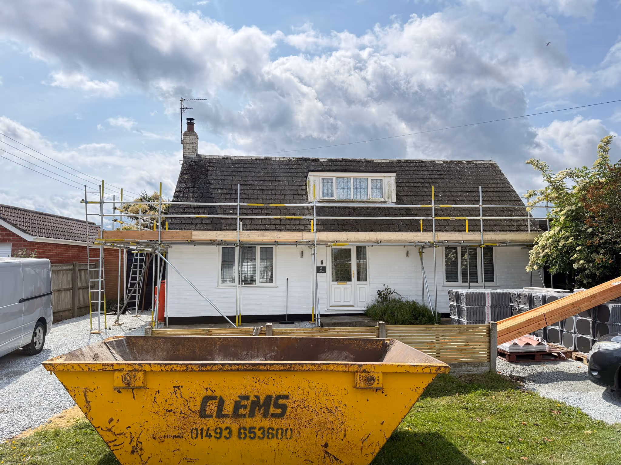 Worker standing on platform of scaffolding.