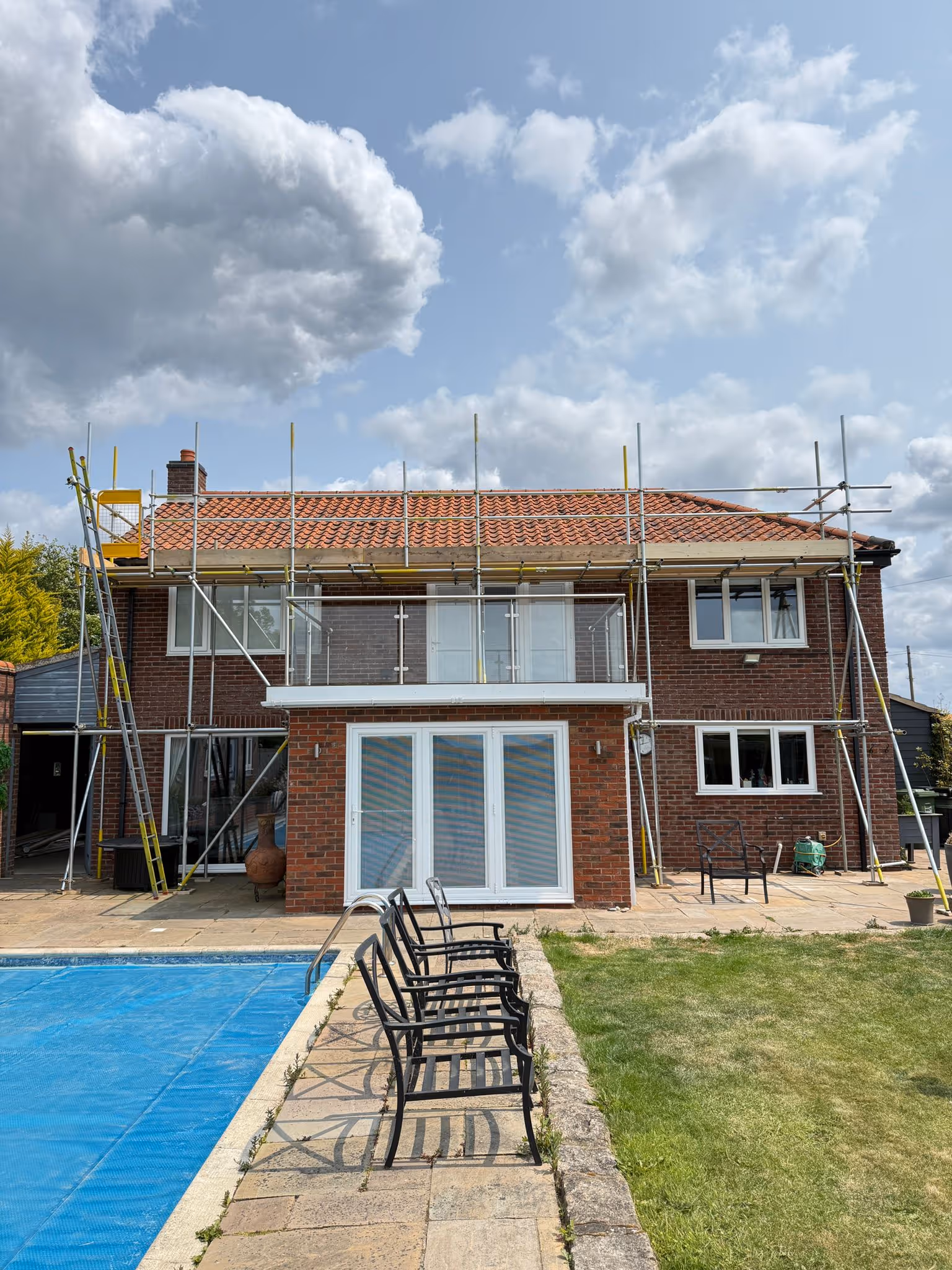 Scaffolding along the back side of large property allowing access to roof.