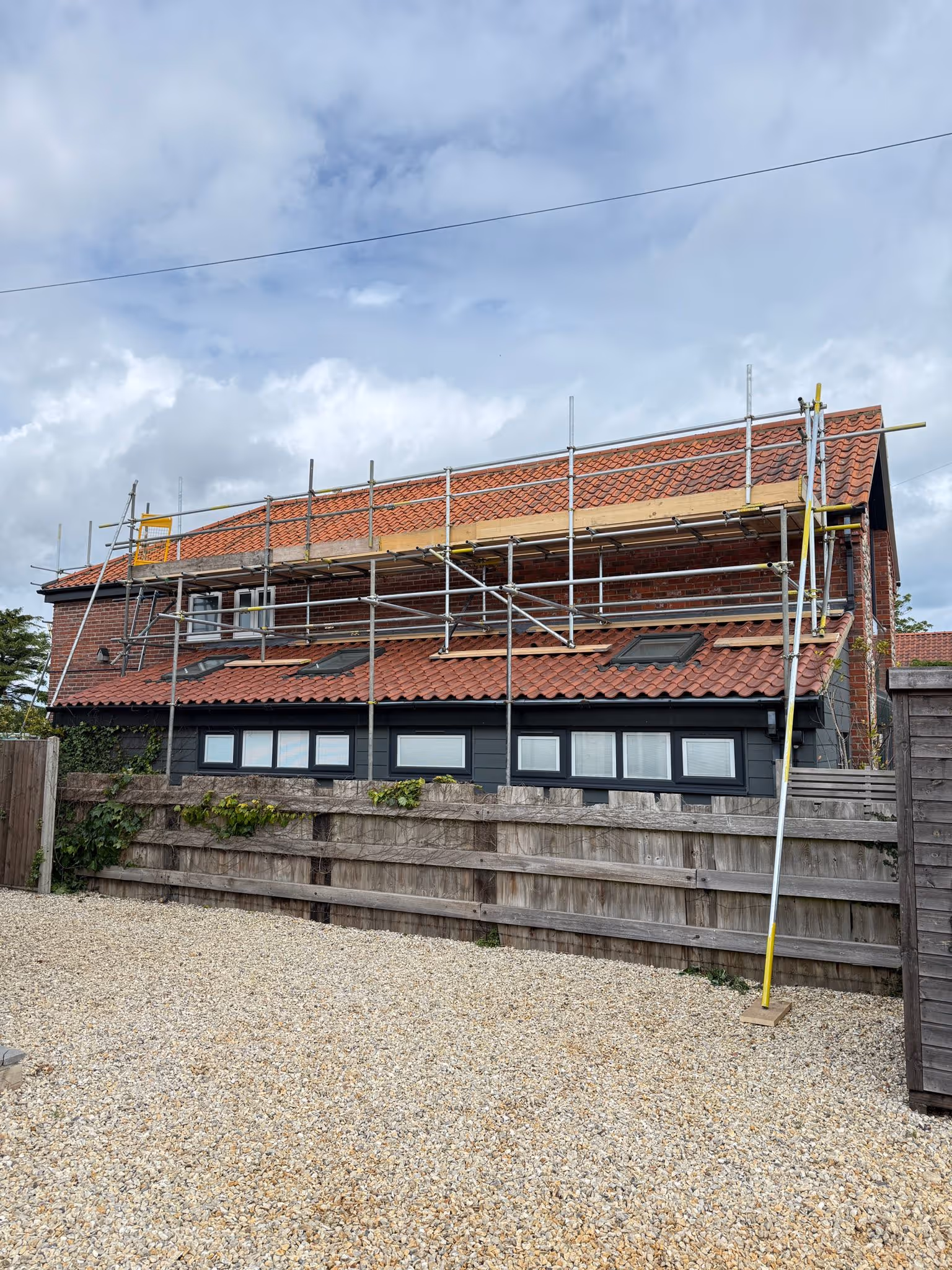 Scaffolding along roof of barn conversion.