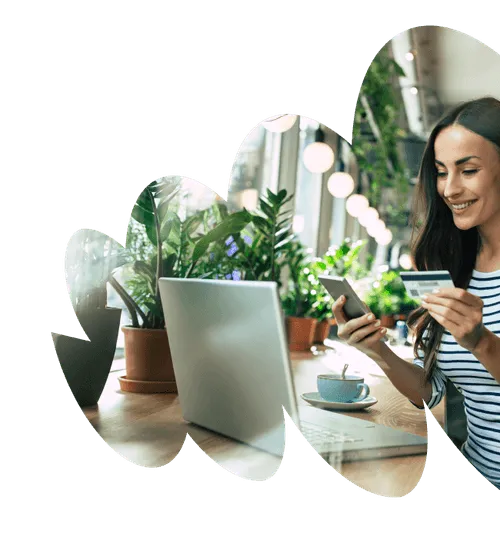 Woman smiling while entering card details to laptop