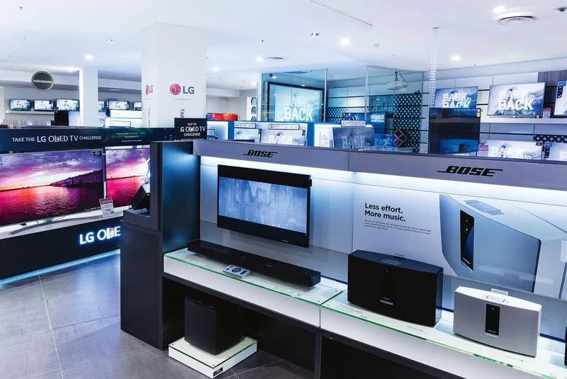 Electronics retail store section featuring displays for LG and Bose products