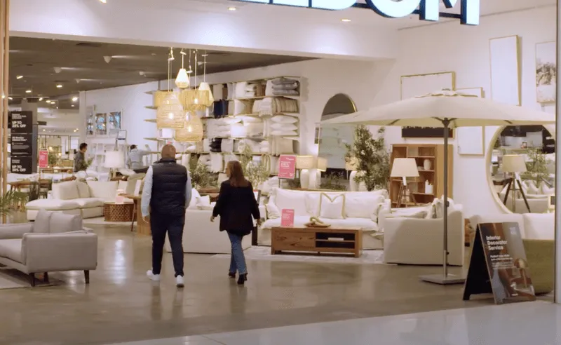 Man and woman walking together through store