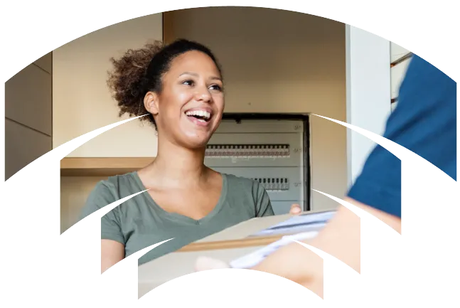 A woman smiling and holding a parcel.