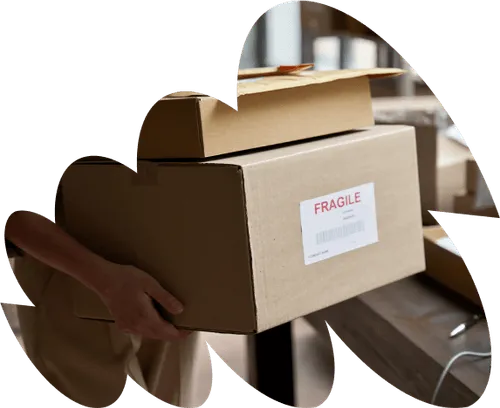 Boxes with fragile sticker on the front, being prepared for delivery