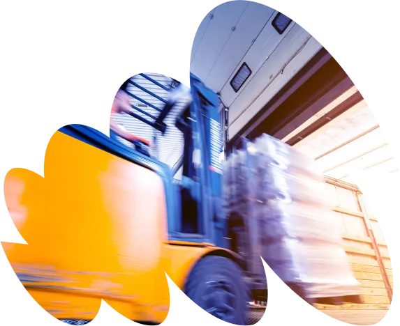 Blurred motion image of a yellow forklift loading a pallet of goods into a truck at a loading dock