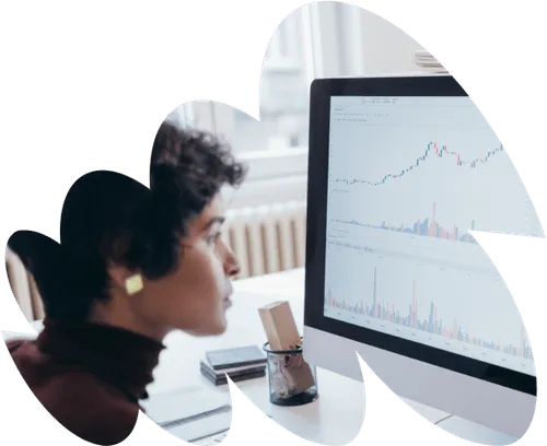 Woman closely analysing data on a computer screen displaying charts and graphs