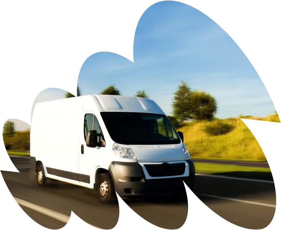 White delivery van driving on a highway with green fields and trees in the background under a clear blue sky