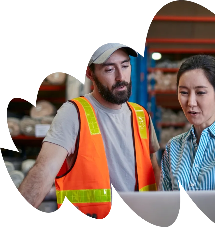 A man and a woman standing in a warehouse.