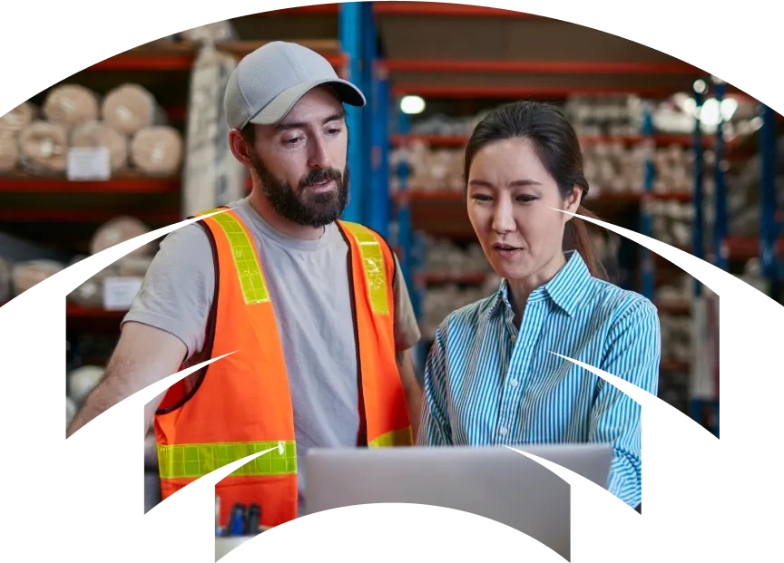 A man and a woman standing in a warehouse.