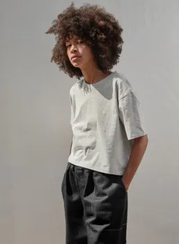 Woman wearing grey t-shirt and black pants