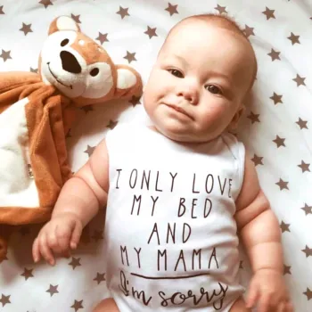 baby lying on floor with toy