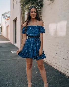 Lady standing in alleyway wearing dress