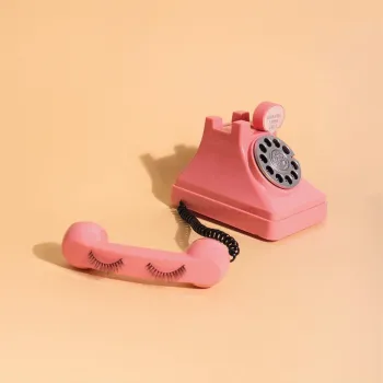 Ol-fashioned phone wih fake eyelashes attatched