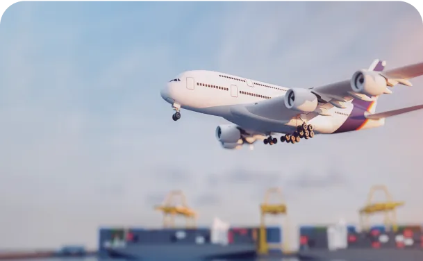 A supply plane flies over an import dock