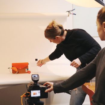 Woman conducting photoshot of handbag