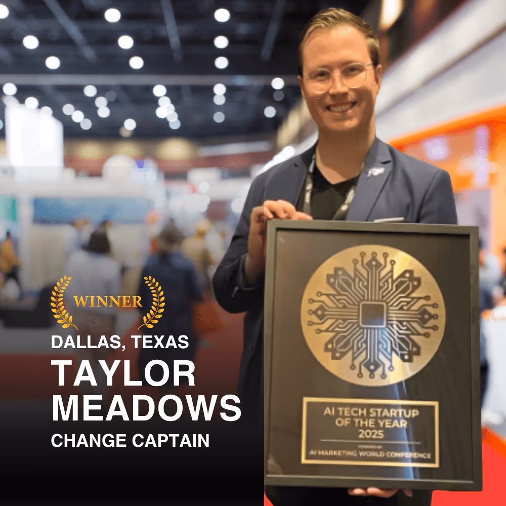 Smiling man holding framed award plaque for AI Tech Startup of the Year 2025 at a conference.