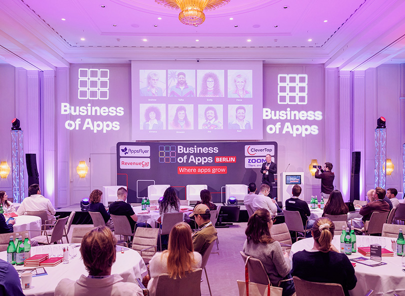 Audience members seated at Business of Apps Berlin conference watching a presentation in a venue