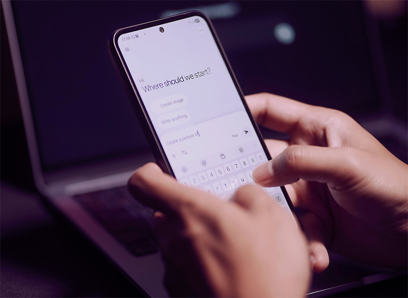 Close up of person's hands using a chatbot on their smartphone