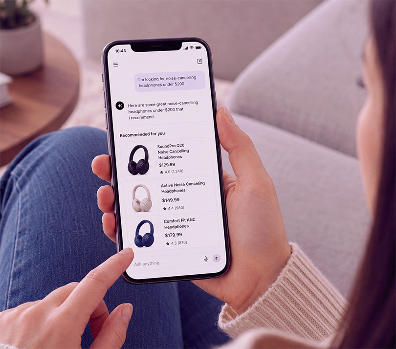 Person using an AI shopping assistant on a smartphone to compare product recommendations and prices.