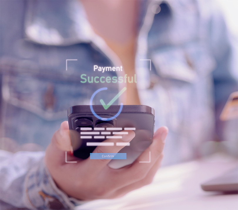 Person holding a smartphone displaying a "Payment Successful" confirmation screen, illustrating mobile ecommerce purchasing