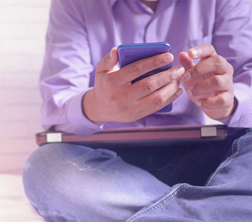 Close up of a man using a smartphone and a tablet