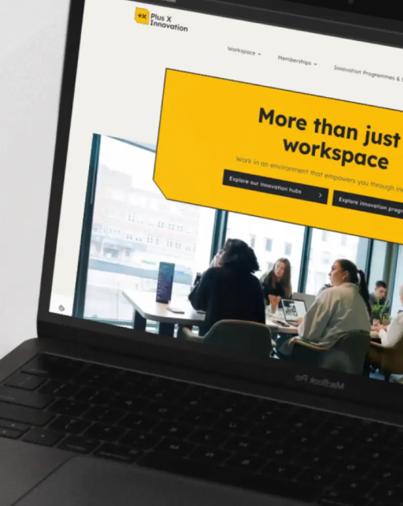 Plus X Innovation's website on a laptop.