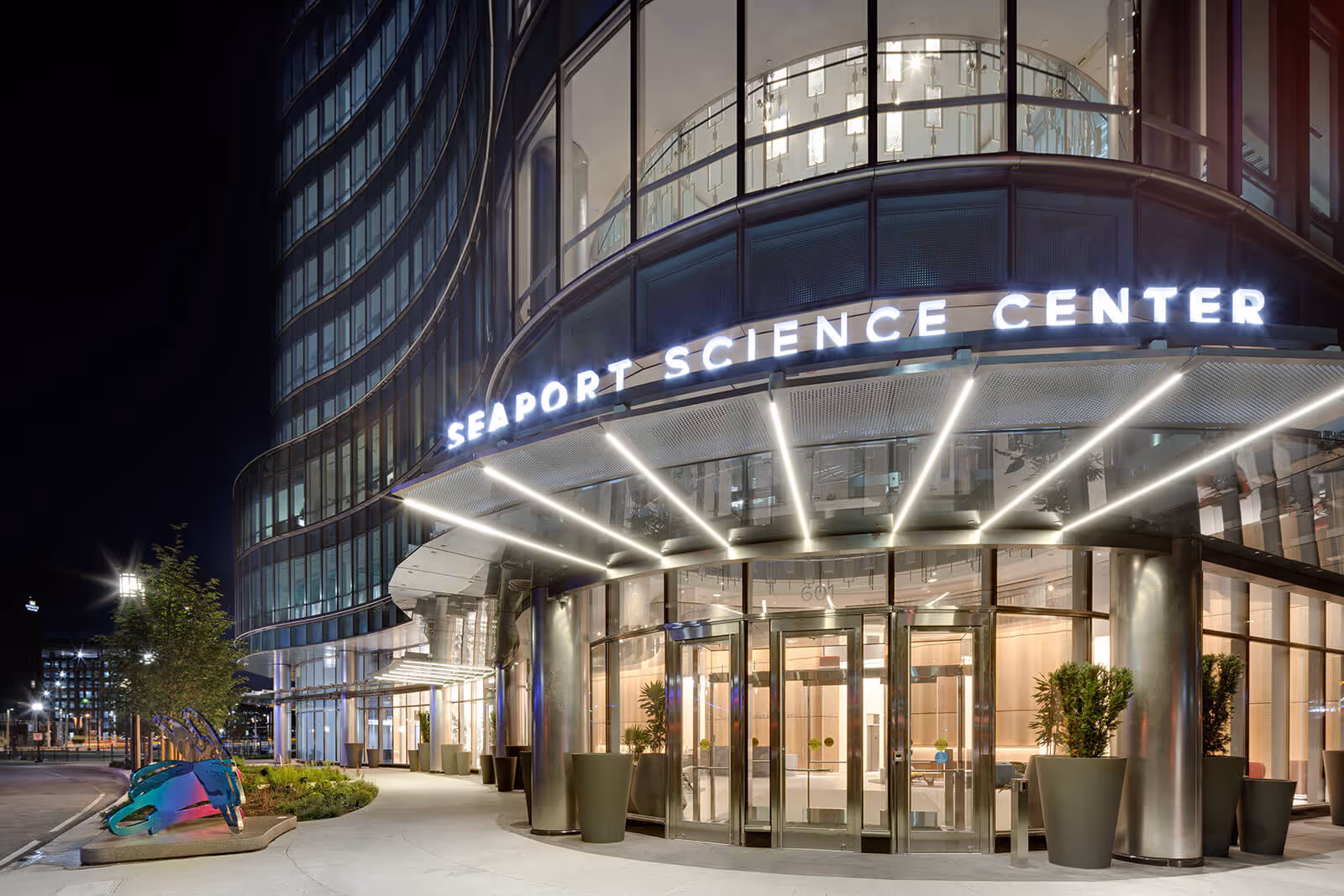Modern Seaport Science Center exterior at night with illuminated entrance