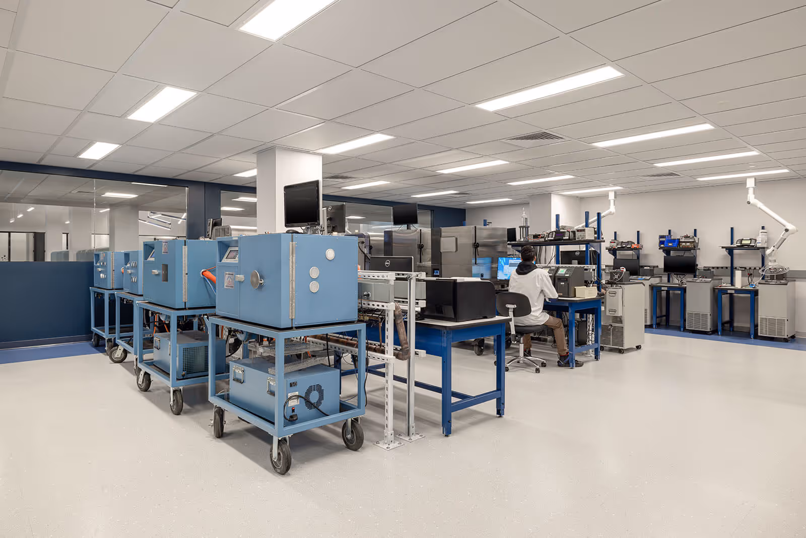 Clean blue and white laboratory with technical equipment and workstations