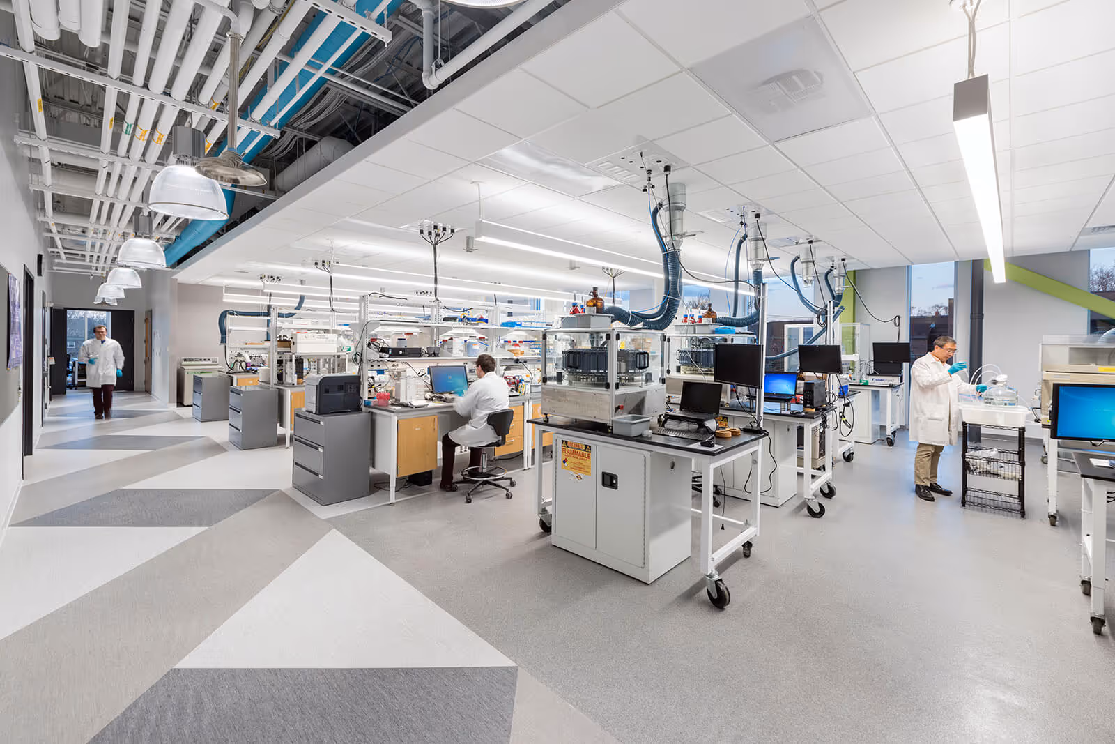 Modern scientific laboratory with researchers working at computer stations