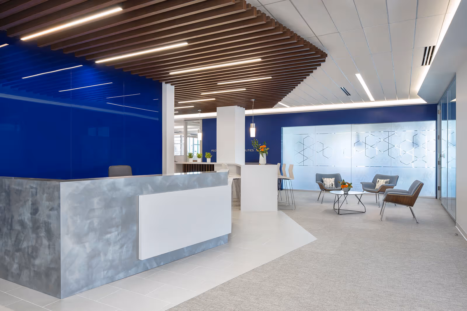 Modern blue and white office lobby with reception desk and seating area