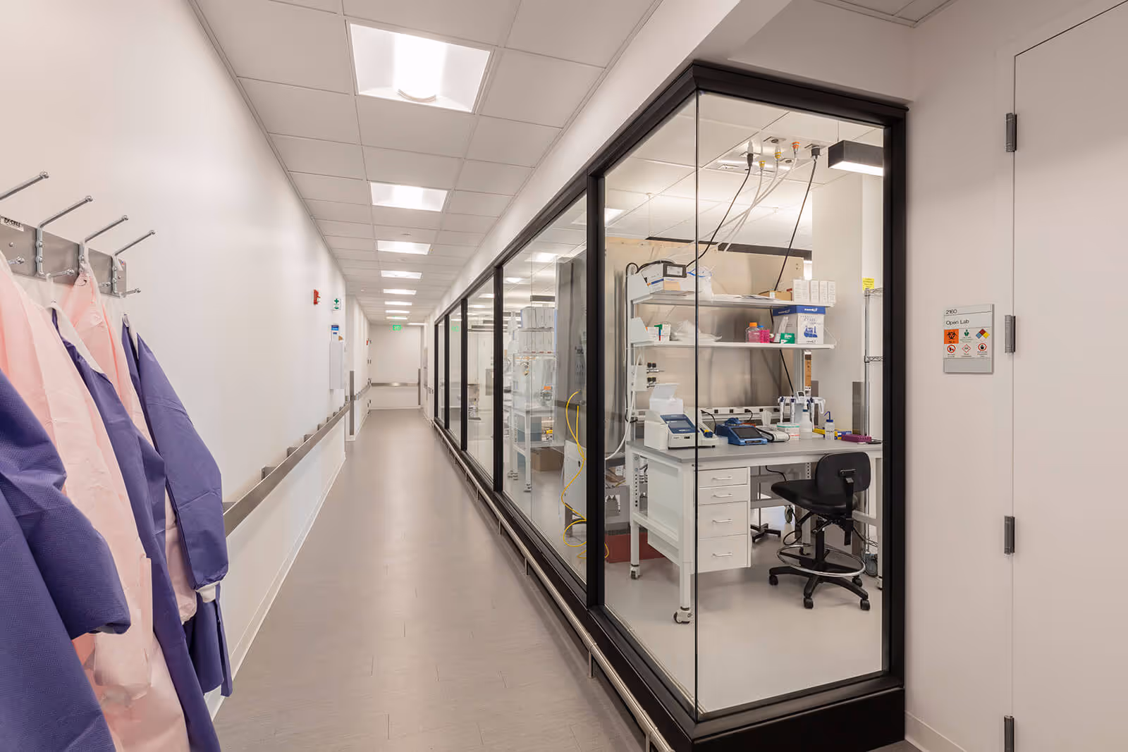 Clean medical research laboratory with glass walls and scientific equipment