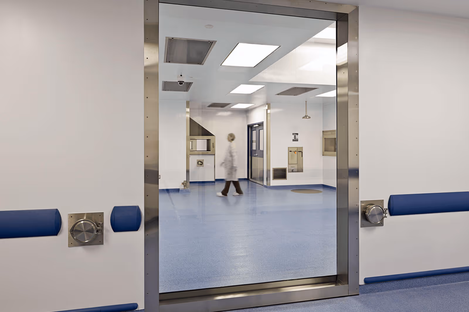 Sterile hospital operating room with blurred figure walking through