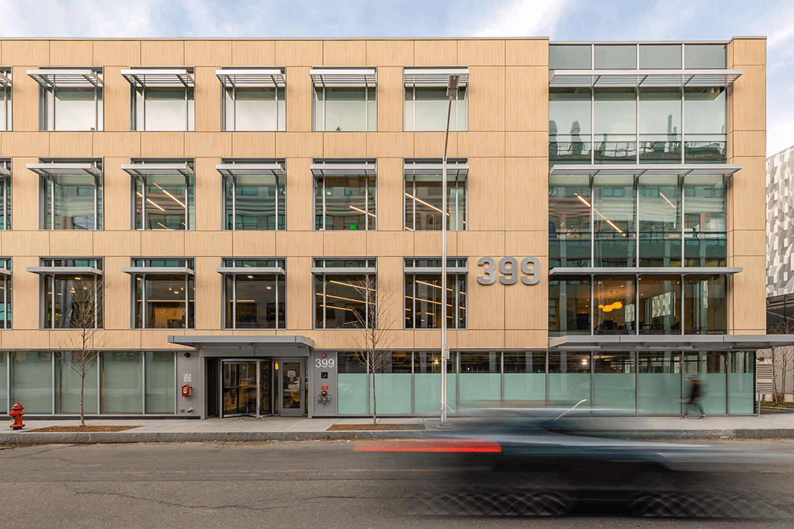 Modern office building with glass windows and wooden facade, number 399