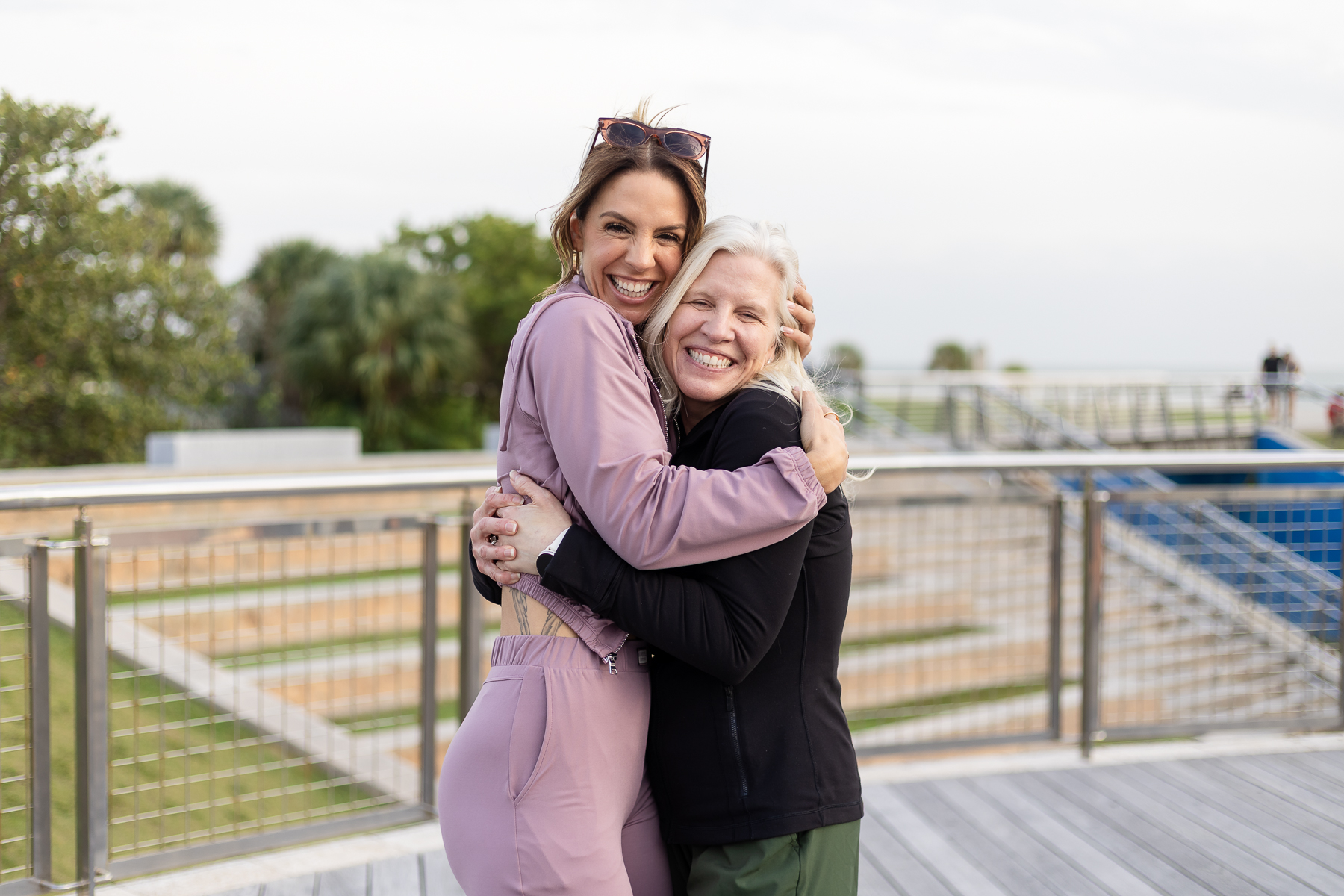 Two WarriorBabe women embracing warmly, smiling