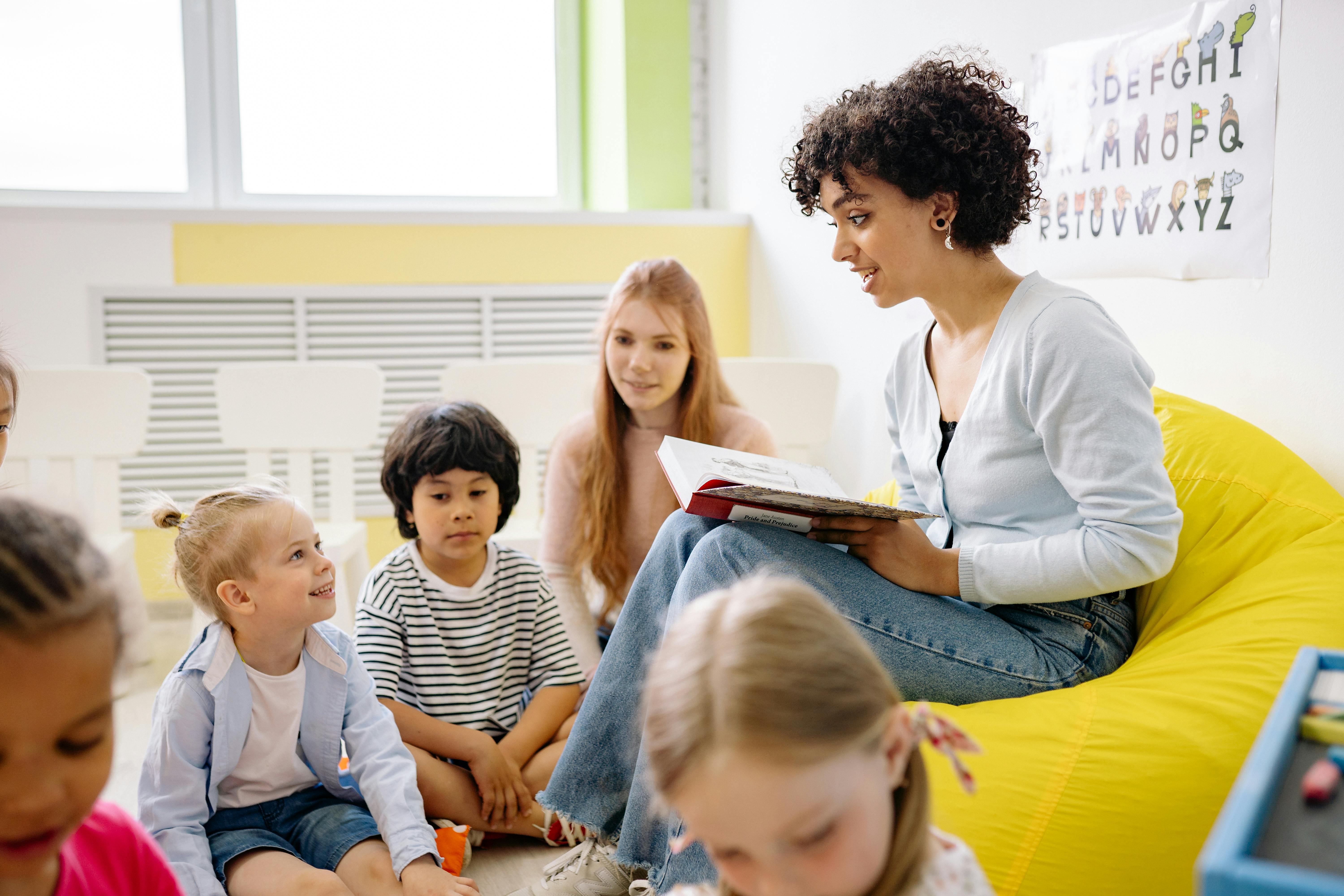 Teacher reading a storybook aloud to young students in classroom