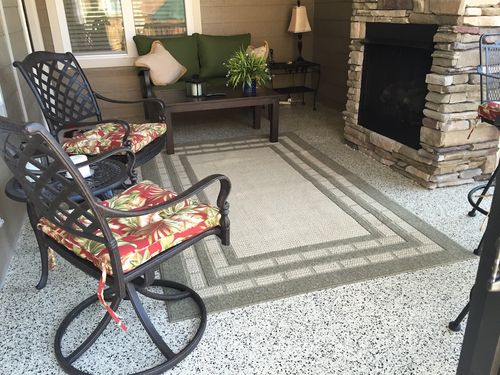 Gray car parked in a clean garage with white cabinets, drawers, and organized shelves along the back wall for optimal garage storage.