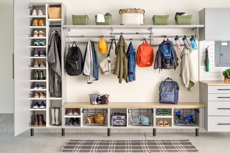Gray car parked in a clean garage with white cabinets, drawers, and organized shelves along the back wall for optimal garage storage.