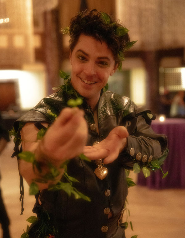 A fae man garbed in plants and foliage offers a sprout at The Paravelle Fantasy Ball in Los Angeles called The Vanguard of Valor. This Southern California Fantasy Experience is the first of it's kind.