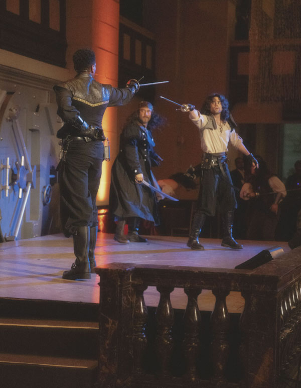 Three swordfighters duel on stage of The Paravelle Ball Fantasy Events Immersive Experience in Los Angeles where characters you interacted with got on stage