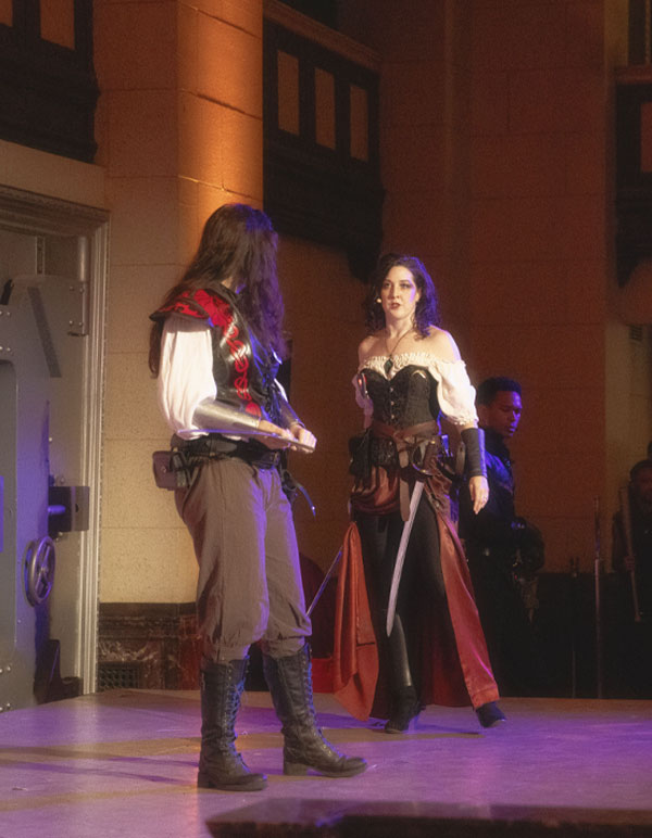 Two women duel on stage at The Majestic Downtown for the Paravelle Fantasy Ball Immersive Theatre experience in Los Angeles in Southern California
