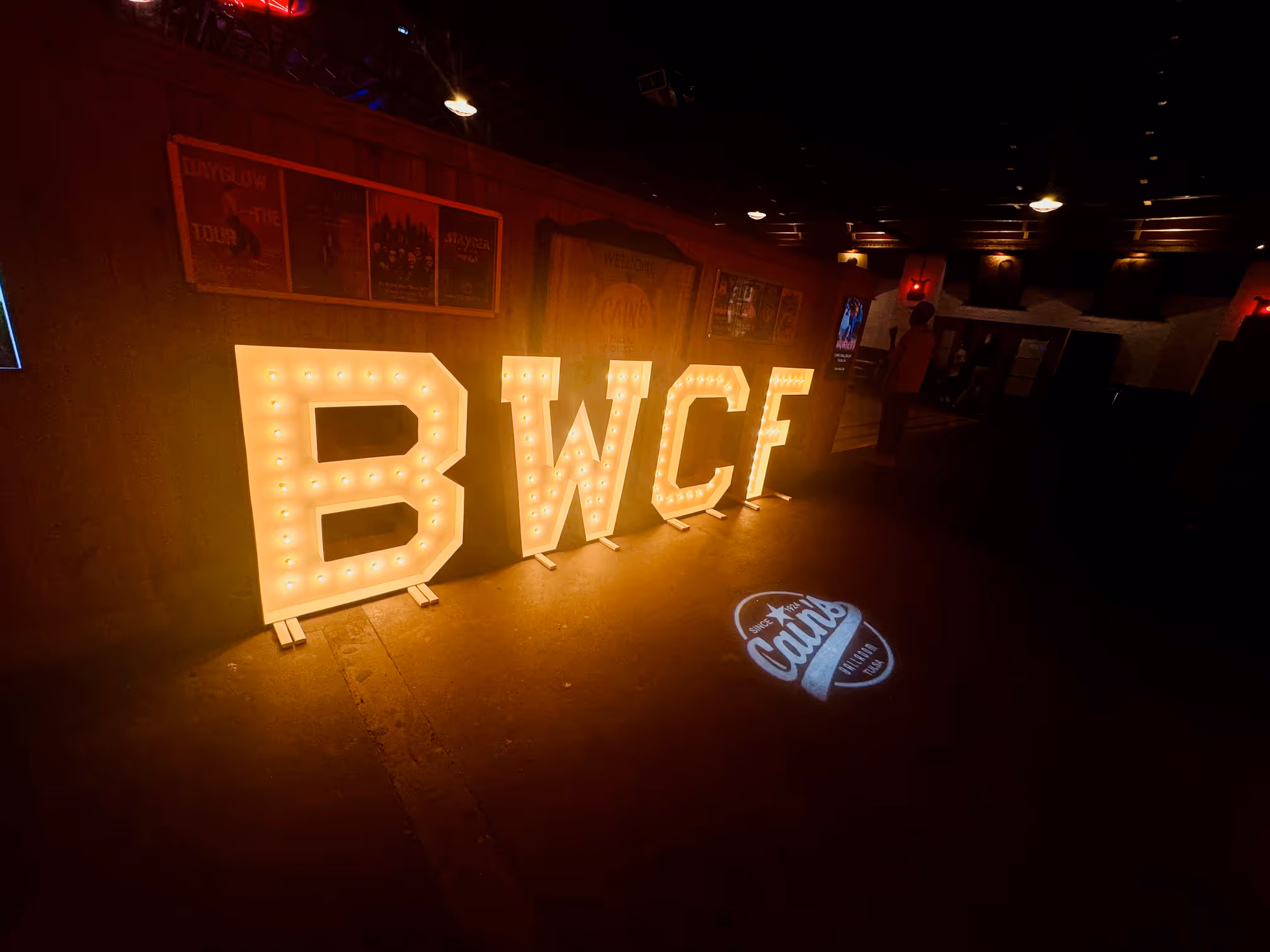 Large lit-up letters spelling BWCF displayed at Cain's Ballroom, welcoming guests to the Blue Whale Comedy Festival in Tulsa.