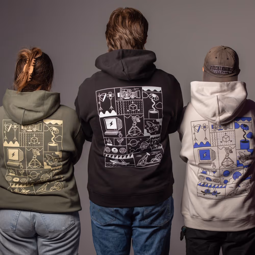 Back view of Signal Factory team showing custom printed graphics on branded hoodies.