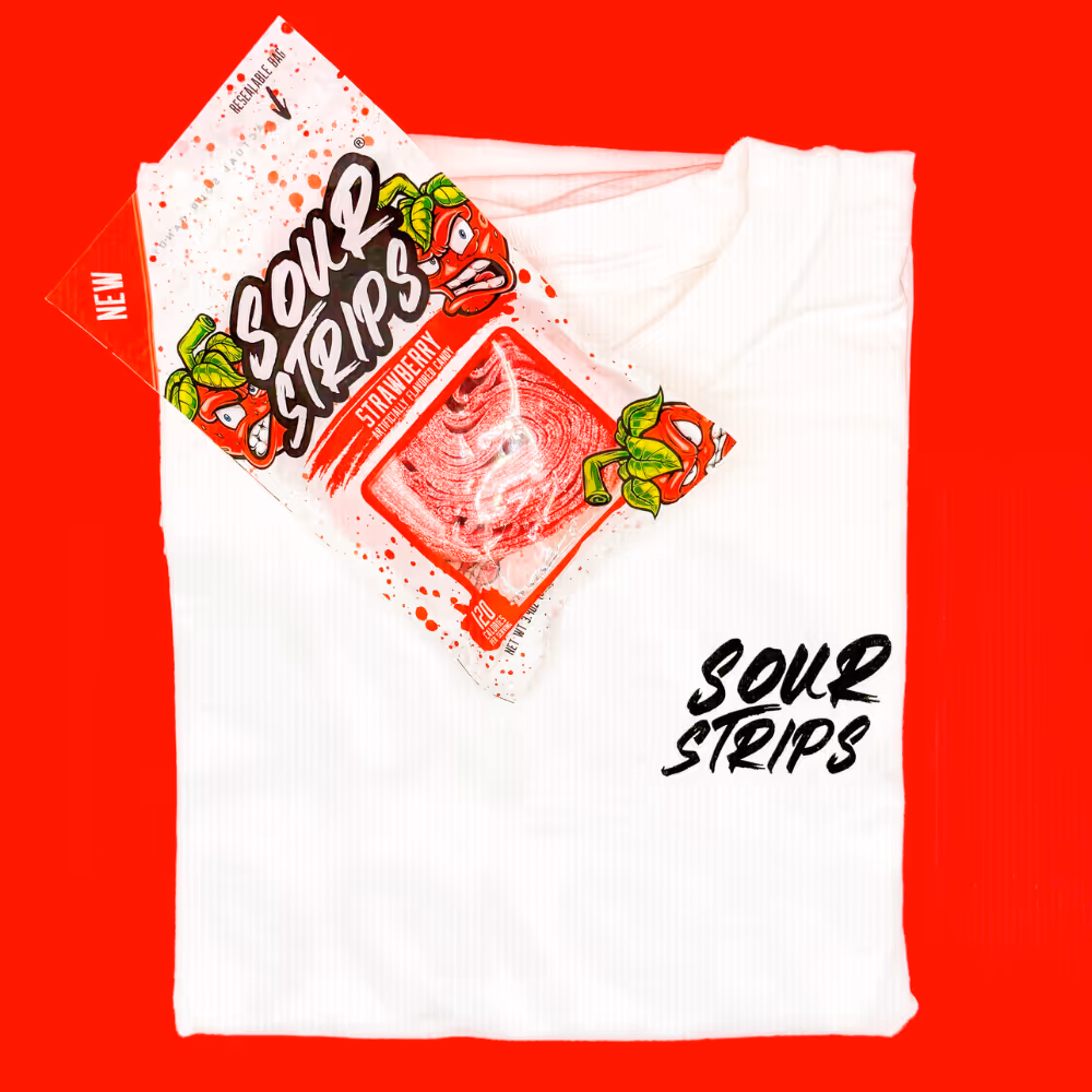White Sour Strips t-shirt paired with strawberry Sour Strips candy pack on bright red background.