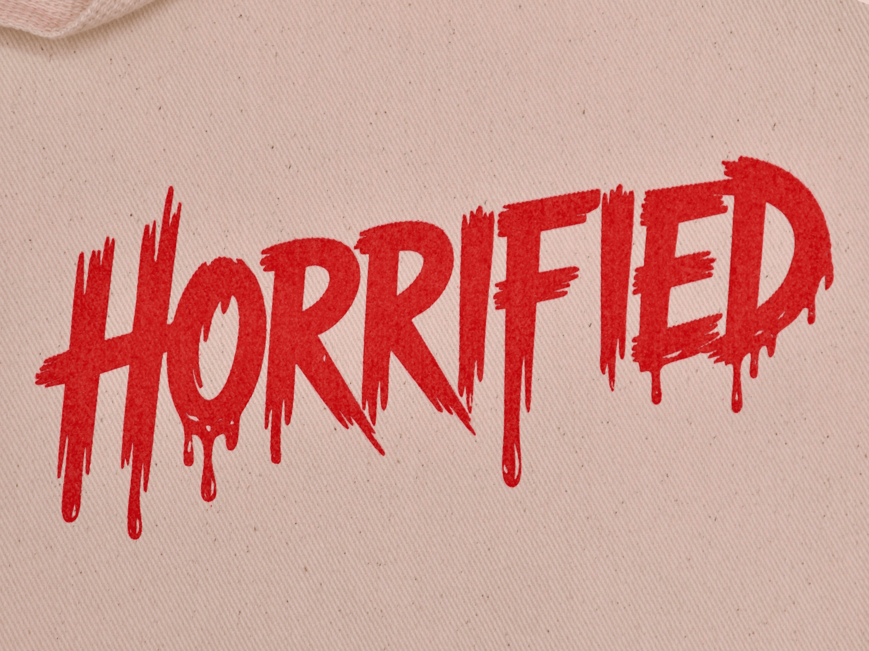 a tote bag with the word horrified screen printed in red