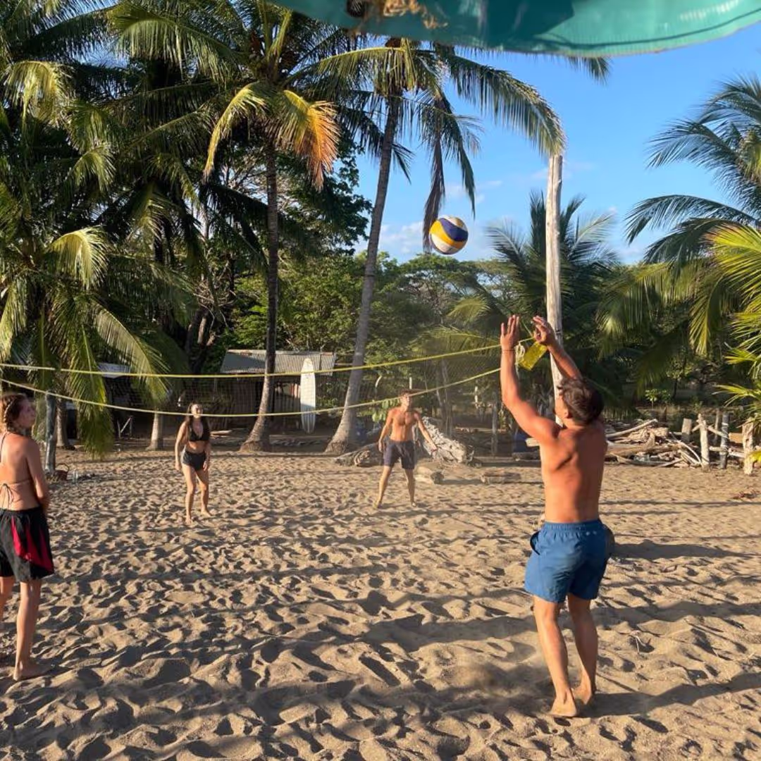Group of young people for The Leap playing beach volleyball on a beach in Costa Rica during their gap year adventure
