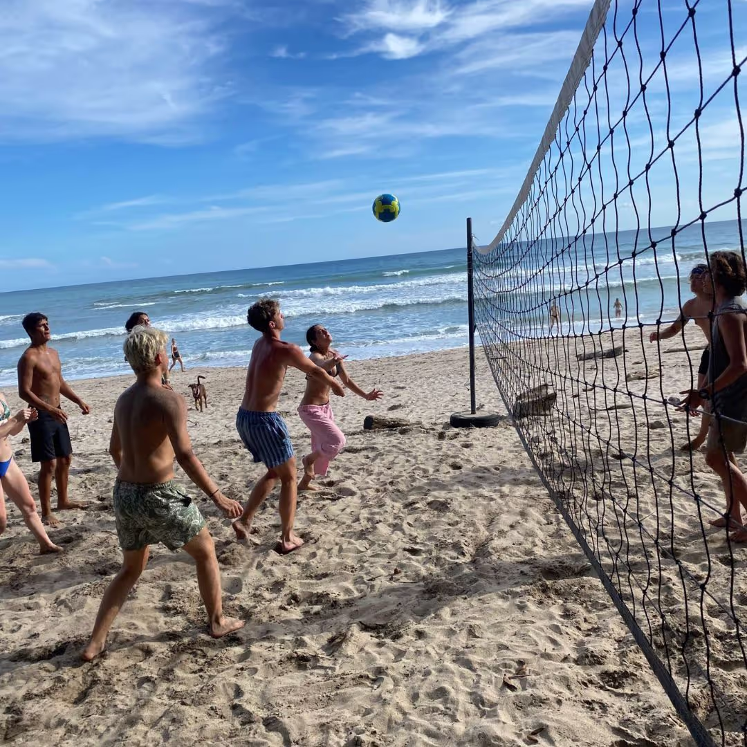 Group of young people for The Leap playing beach volleyball on a beach in Costa Rica during their gap year adventure